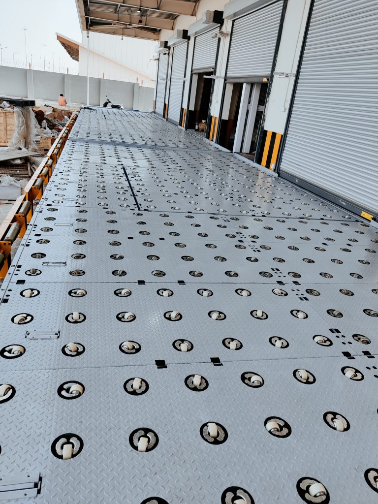 Heavy-duty castor deck platform with integrated wheel rollers for smooth cargo movement and warehouse loading operations.