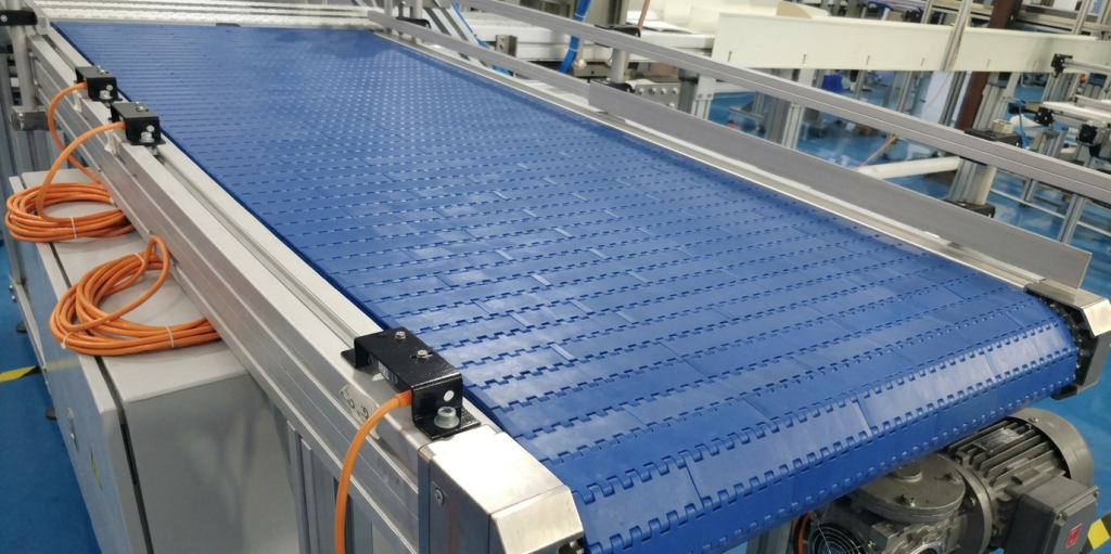 Modular belt conveyor system used for industrial material handling and product transportation.