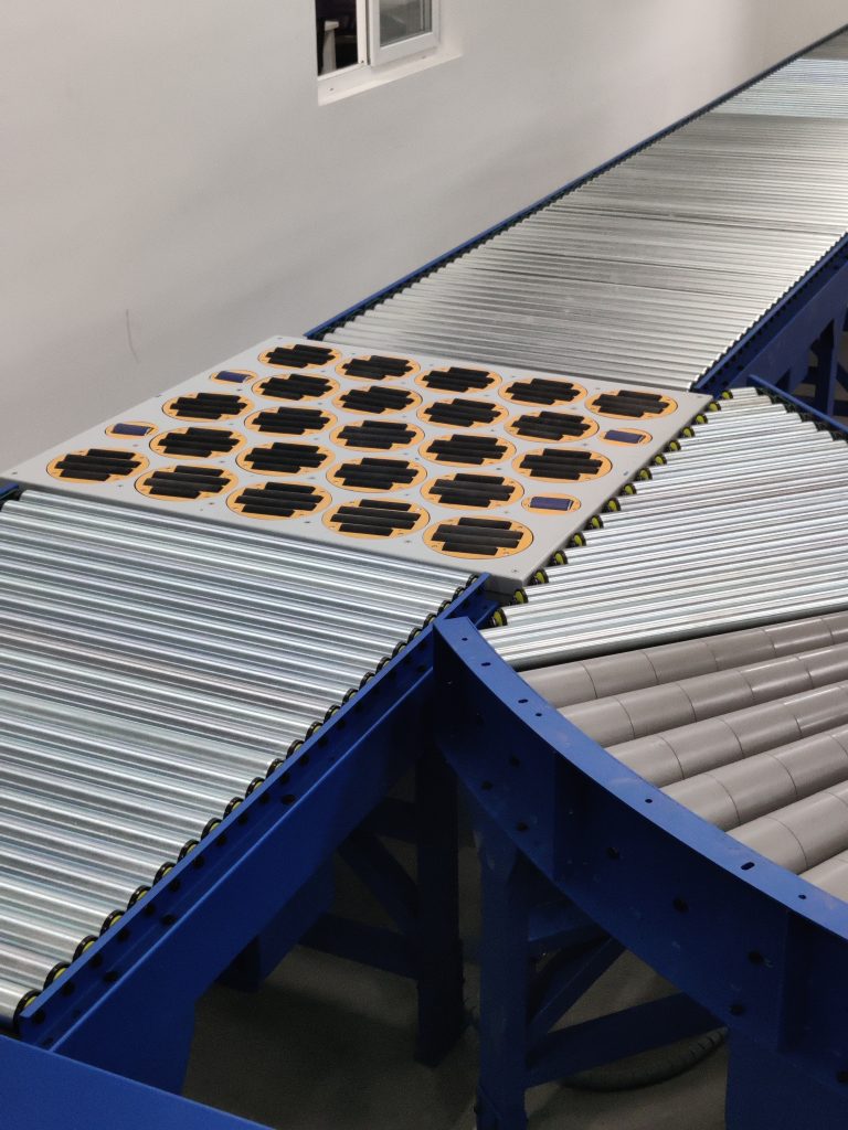 Swivel sorter conveyor system with multiple rotating wheel modules for package sorting and material handling.