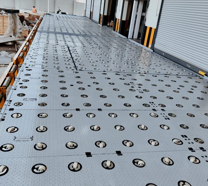 Heavy-duty castor deck platform with integrated wheel rollers for smooth cargo movement and warehouse loading operations.