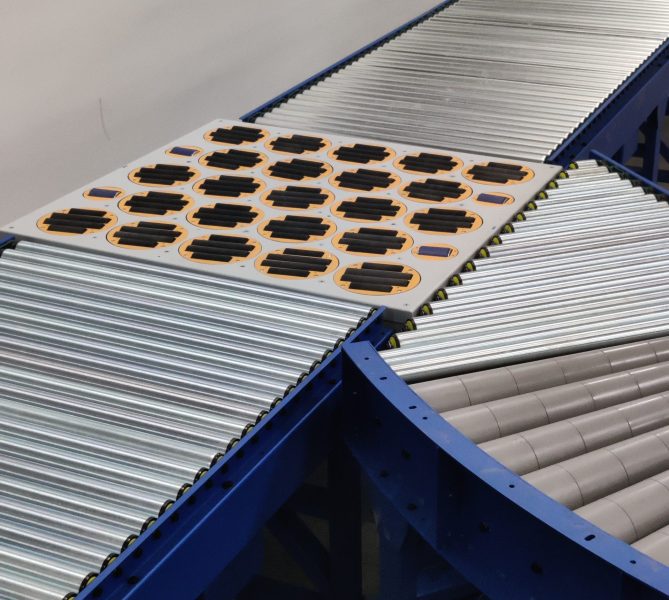 Swivel sorter conveyor system with multiple rotating wheel modules for package sorting and material handling.